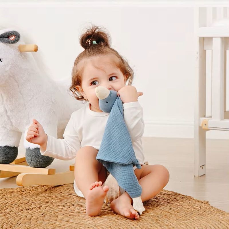 bebe-assis-joue-avec-doudou-canard