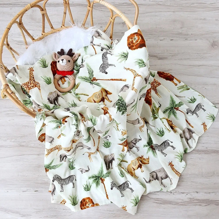 couverture-bebe-en-mousseline-de-conton-motif-jungle-sur-une-chaise-avec-doudou