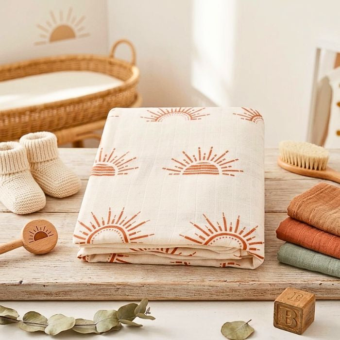 couverture bebe motif soleil en gaze de coton pliee avec des accessoires bebe