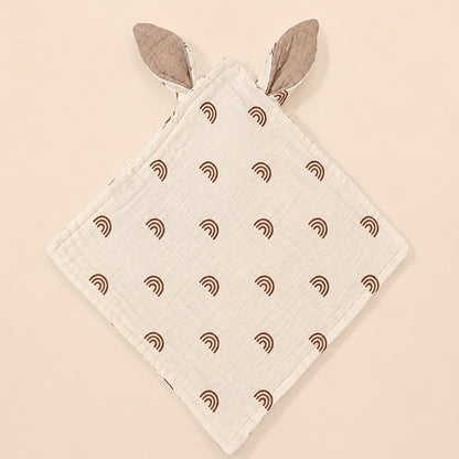 doudou bébé arc en ciel avec oreilles lapin en gaze de coton beige motifs arcs-en-ciel marron posé à plat