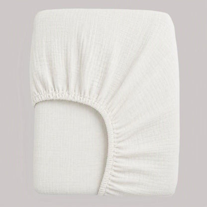 drap housse bébé gaze de coton blanc plié avec élastques