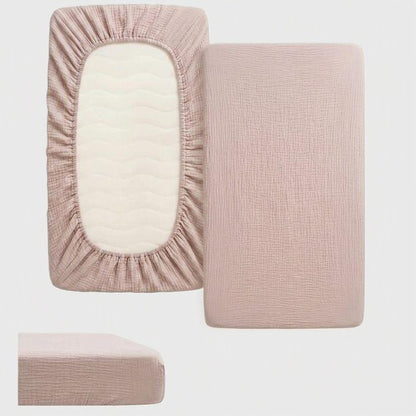 drap housse lit bébé beige uni de face et de dos avec bords élastiqués autour