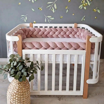 Tresse de lit 4 brins pêche en velours disposée dans un lit blanc à barreaux chambre élégante avec décoration végétale 